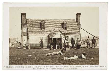 (SLAVERY AND ABOLITION--PHOTOGRAPHY.) Group of Contrabands in front of Allen’s Farmhouse near Williamsburg Road (supplied title.)